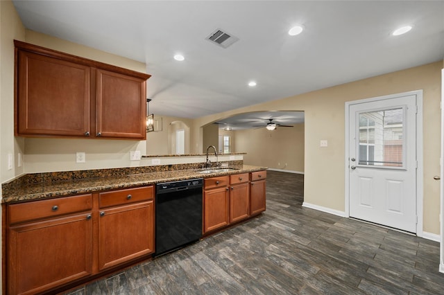 kitchen with black dishwasher, a sink, a peninsula, a ceiling fan, and arched walkways