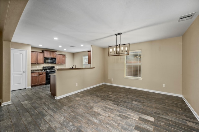 kitchen with black appliances, dark wood finished floors, a chandelier, baseboards, and recessed lighting