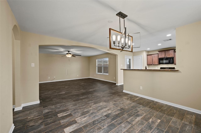 unfurnished living room featuring arched walkways, ceiling fan, recessed lighting, baseboards, and dark wood-style flooring