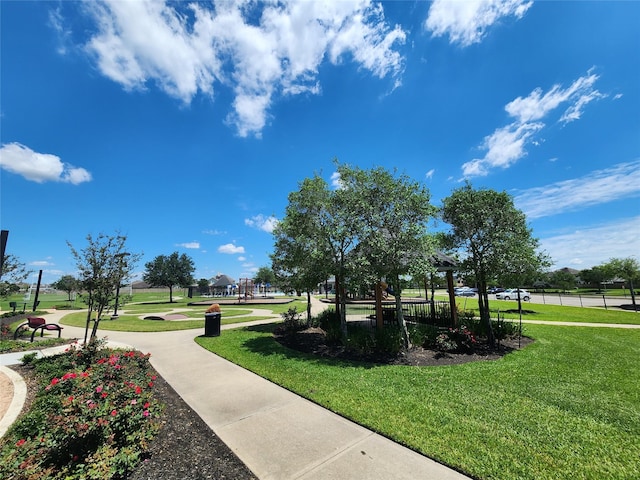 view of property's community with a lawn