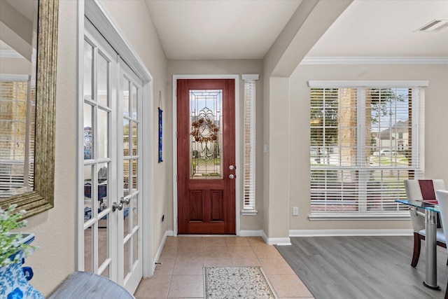 4603 Tamara Heights Ln, Sugar Land, TX 77479 - foyer entrance featuring baseboards, french doors, crown molding, and wood finished floors