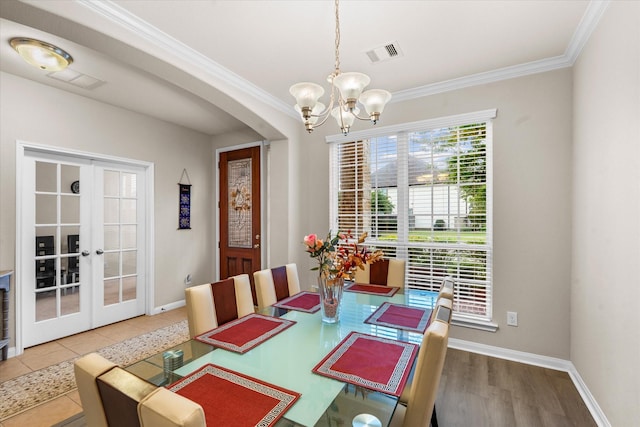 4603 Tamara Heights Ln, Sugar Land, TX 77479 - dining room featuring crown molding, a chandelier, french doors, baseboards, and arched walkways