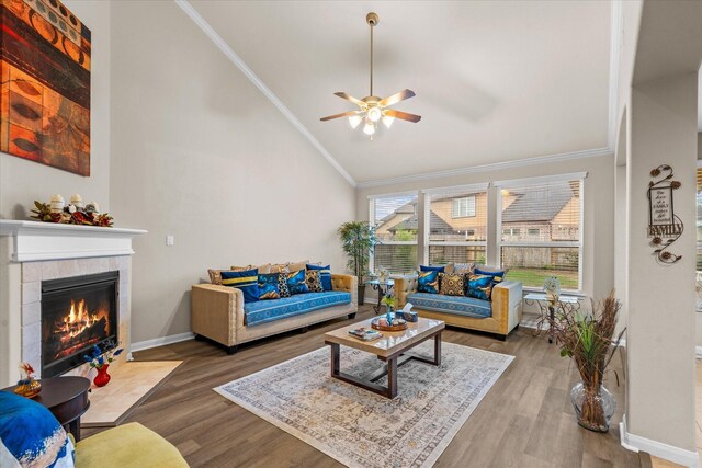 4603 Tamara Heights Ln, Sugar Land, TX 77479 - living area with vaulted ceiling, ceiling fan, crown molding, wood finished floors, and a fireplace