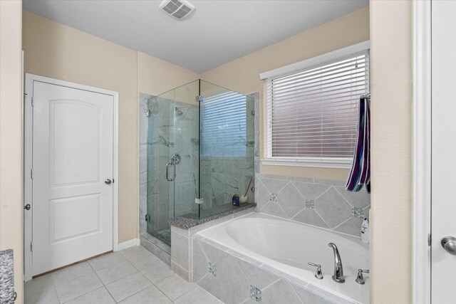 4603 Tamara Heights Ln, Sugar Land, TX 77479 - bathroom with tile patterned flooring, a shower stall, a bath, and baseboards