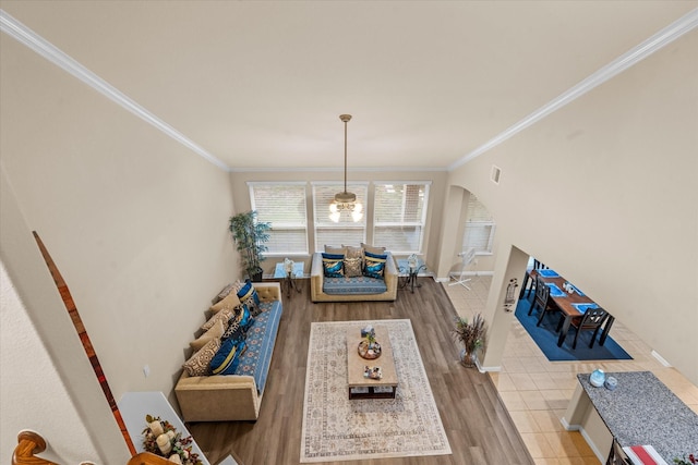 4603 Tamara Heights Ln, Sugar Land, TX 77479 - living area featuring crown molding, light wood-style flooring, arched walkways, and baseboards