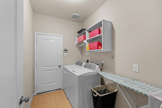 4603 Tamara Heights Ln, Sugar Land, TX 77479 - laundry room featuring washing machine and dryer, light tile patterned floors, and baseboards