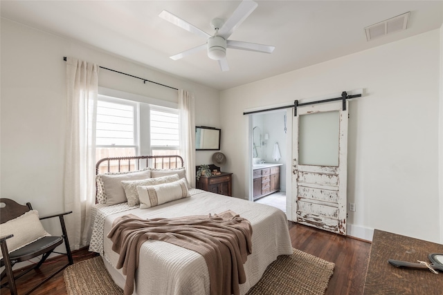 108 E 27th St, Houston, TX 77008 - bedroom with a barn door, wood finished floors, and a ceiling fan