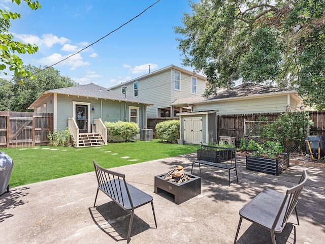 108 E 27th St, Houston, TX 77008 - back of property with an outdoor fire pit, a patio area, a storage shed, a garden, and central AC unit