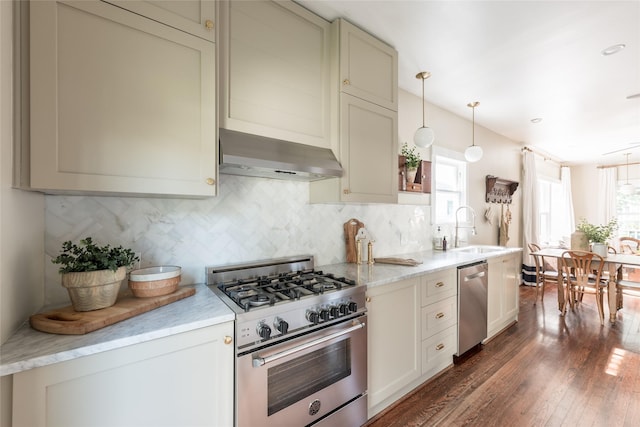 108 E 27th St, Houston, TX 77008 - kitchen featuring stainless steel appliances, healthy amount of natural light, a sink, and wall chimney exhaust hood