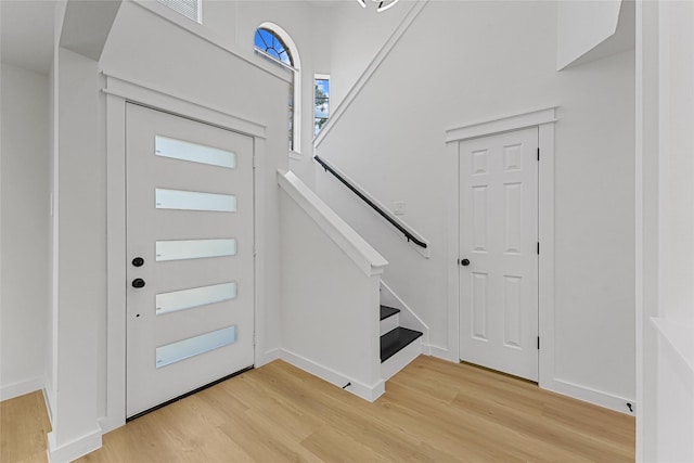 foyer featuring light wood finished floors and stairs