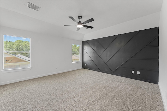 unfurnished room with baseboards, carpet, a ceiling fan, and lofted ceiling
