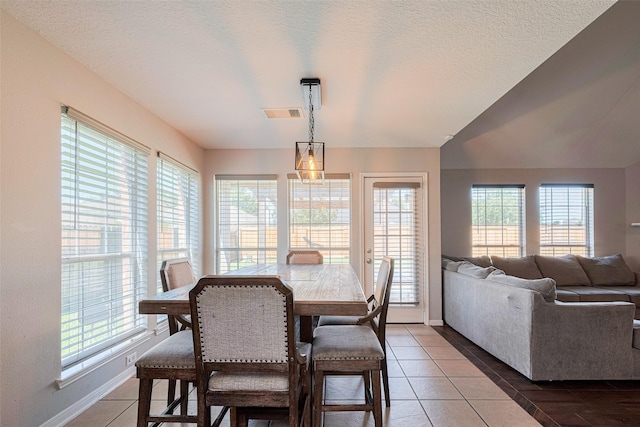 2202 Megellan Point Ln, Pearland, TX 77584 - dining area featuring baseboards, light tile patterned flooring, and a textured ceiling