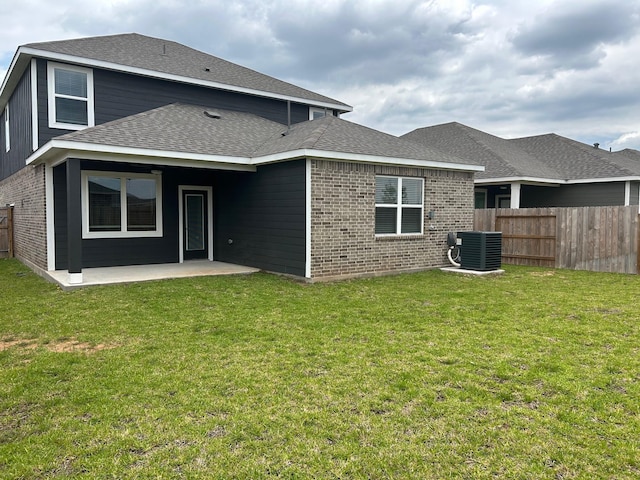 10811 Bright Beacon Dr, Beasley, TX 77417 - rear view of house with brick siding, central AC, a patio, and a shingled roof