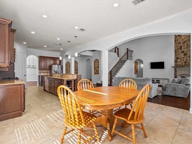 913 Ember Hills Ln, Friendswood, TX 77546 - dining space featuring arched walkways, stairway, recessed lighting, crown molding, and light tile patterned flooring
