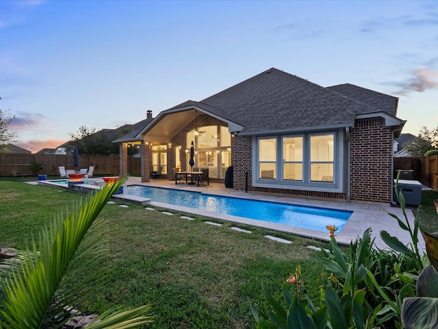 913 Ember Hills Ln, Friendswood, TX 77546 - back of house with a shingled roof, a patio area, and brick siding