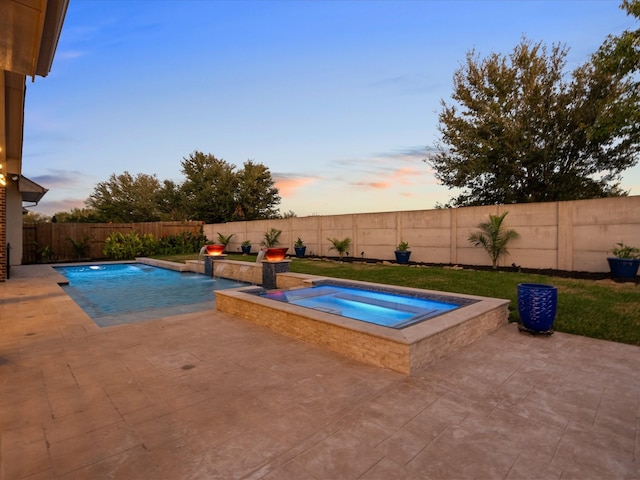 913 Ember Hills Ln, Friendswood, TX 77546 - pool at dusk featuring an in-ground hot tub, a patio area, and a fenced backyard