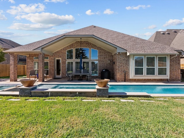913 Ember Hills Ln, Friendswood, TX 77546 - back of house with brick siding, an outdoor pool, roof with shingles, and a patio