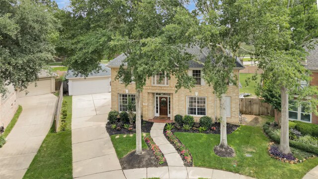 22802 Pennyrile Ln, Katy, TX 77450 - view of front of property with brick siding, concrete driveway, a shingled roof, and a garage