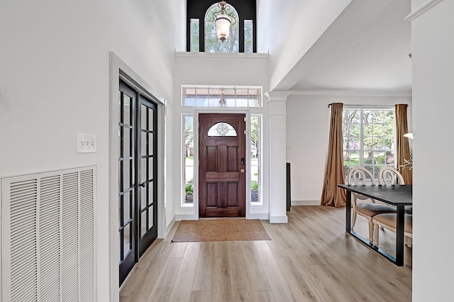 22802 Pennyrile Ln, Katy, TX 77450 - entrance foyer with light wood-type flooring, a towering ceiling, baseboards, and crown molding