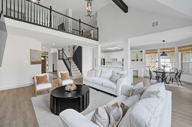 22802 Pennyrile Ln, Katy, TX 77450 - living room with light wood finished floors, high vaulted ceiling, beam ceiling, stairway, and baseboards