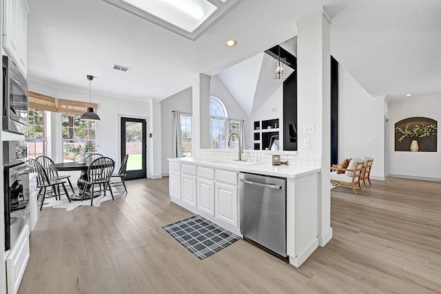 22802 Pennyrile Ln, Katy, TX 77450 - kitchen with appliances with stainless steel finishes, light wood-style floors, white cabinets, vaulted ceiling, and baseboards