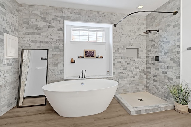 22802 Pennyrile Ln, Katy, TX 77450 - bathroom with a stall shower, a freestanding tub, and wood finished floors
