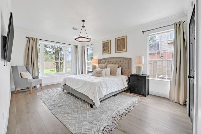 22802 Pennyrile Ln, Katy, TX 77450 - bedroom featuring a chandelier, crown molding, and light wood-style flooring