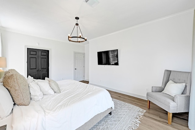 22802 Pennyrile Ln, Katy, TX 77450 - bedroom with a chandelier, light wood-style flooring, crown molding, and baseboards