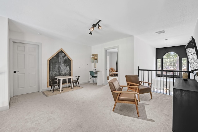 22802 Pennyrile Ln, Katy, TX 77450 - sitting room featuring carpet, an upstairs landing, rail lighting, and baseboards