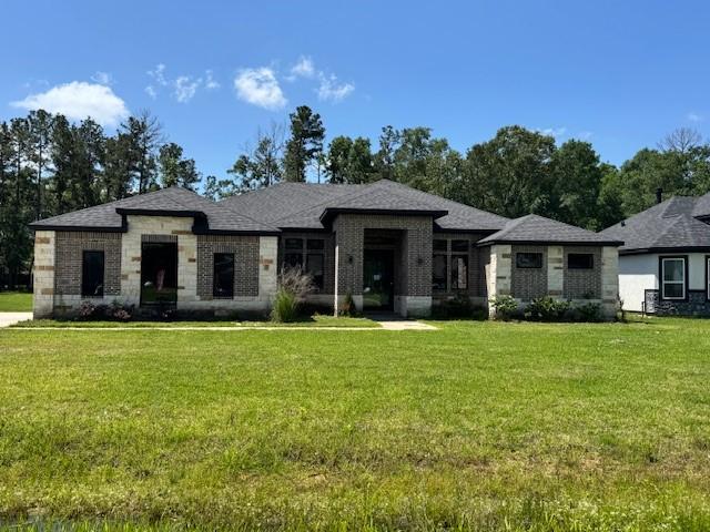 409 Rd 66111, Dayton, TX 77535 - view of front of property featuring a front yard and brick siding