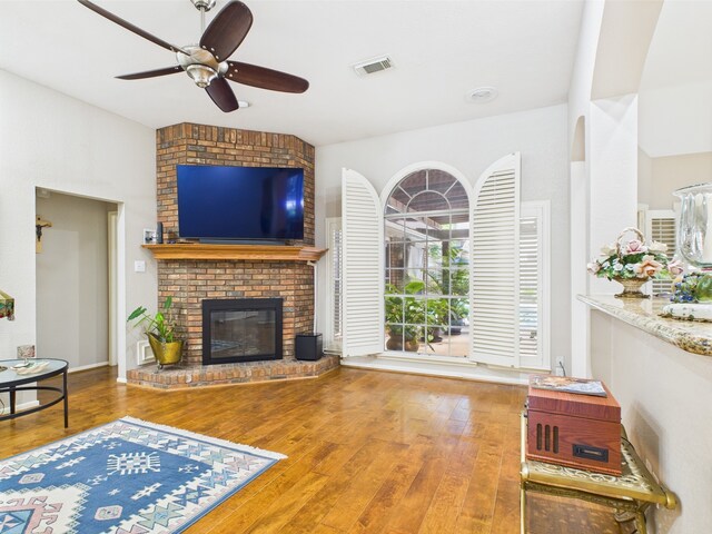 4210 Rock Springs Dr, Houston, TX 77345 - living room featuring hardwood / wood-style flooring, a ceiling fan, and a fireplace