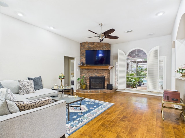 4210 Rock Springs Dr, Houston, TX 77345 - living room featuring a ceiling fan, a brick fireplace, and wood finished floors