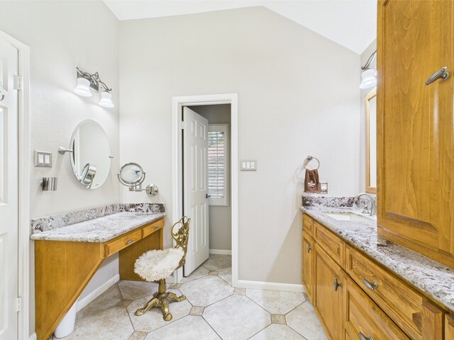 4210 Rock Springs Dr, Houston, TX 77345 - full bath with two vanities, vaulted ceiling, tile patterned floors, and baseboards