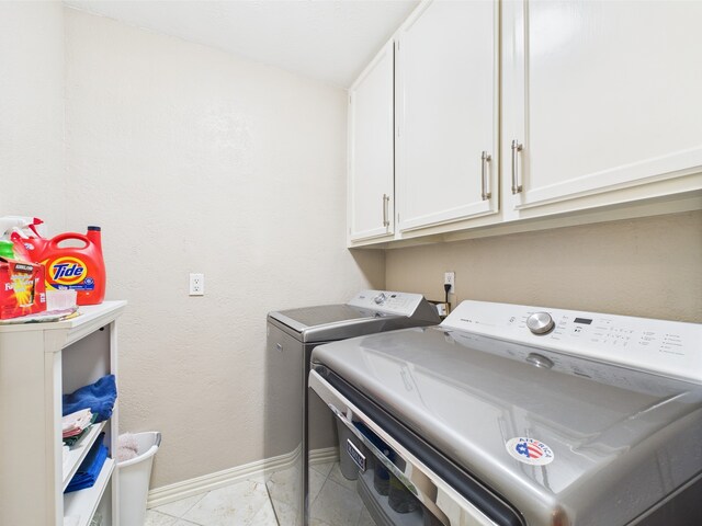 4210 Rock Springs Dr, Houston, TX 77345 - washroom with cabinet space, washing machine and clothes dryer, baseboards, and light tile patterned floors