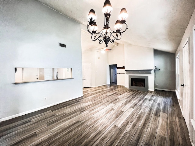 21510 N Tangle Creek Ln, Spring, TX 77388 - unfurnished living room featuring wood finished floors, a chandelier, baseboards, and high vaulted ceiling