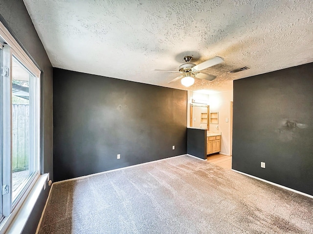 21510 N Tangle Creek Ln, Spring, TX 77388 - spare room with a textured ceiling, light colored carpet, a ceiling fan, and baseboards