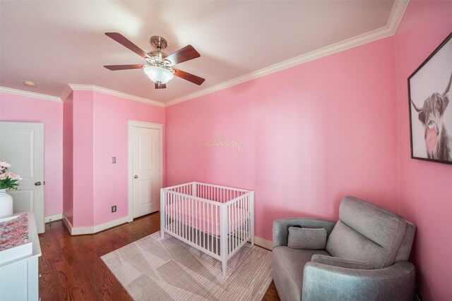 1529 Prince St, Houston, TX 77008 - bedroom with ornamental molding, wood finished floors, baseboards, a crib, and a ceiling fan