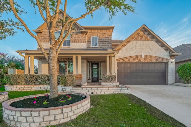 707 Fresh Sage Xing, Richmond, TX 77406 - view of front facade with an attached garage, a porch, concrete driveway, brick siding, and stone siding