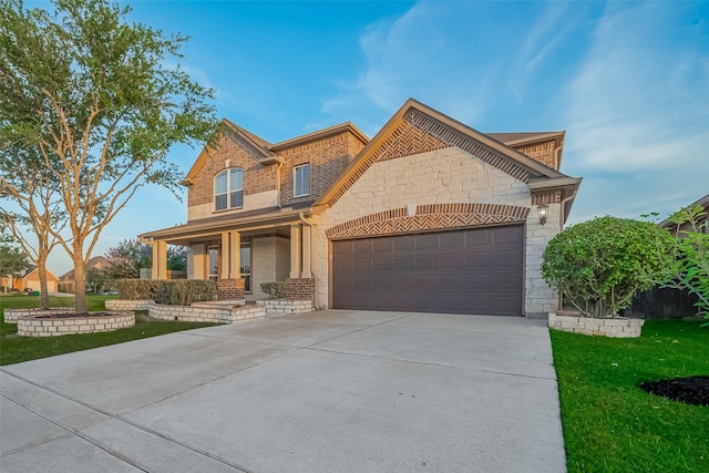 707 Fresh Sage Xing, Richmond, TX 77406 - view of front facade featuring stone siding, a garage, covered porch, and driveway