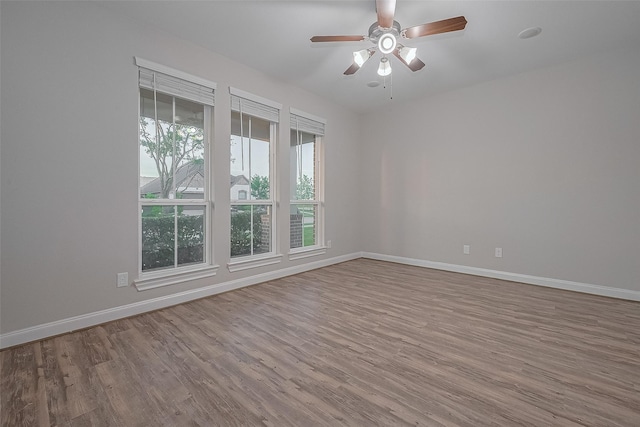 707 Fresh Sage Xing, Richmond, TX 77406 - unfurnished room with wood finished floors, baseboards, and ceiling fan