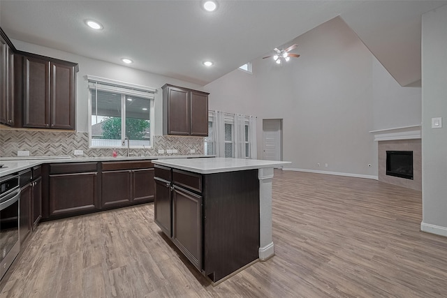 707 Fresh Sage Xing, Richmond, TX 77406 - kitchen featuring ceiling fan, dark brown cabinetry, tasteful backsplash, light countertops, and vaulted ceiling