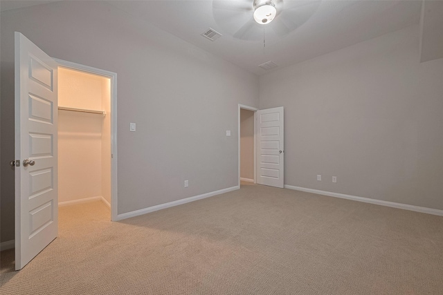707 Fresh Sage Xing, Richmond, TX 77406 - unfurnished bedroom with a walk in closet, light carpet, baseboards, a closet, and ceiling fan