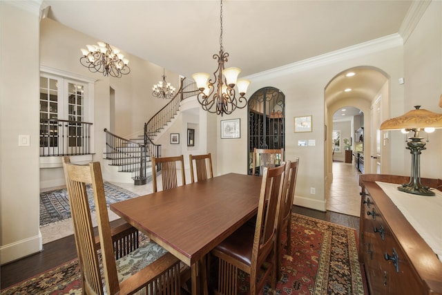 7106 Sentinel Fls, Missouri City, TX 77459 - dining area featuring arched walkways, a chandelier, ornamental molding, baseboards, and stairs
