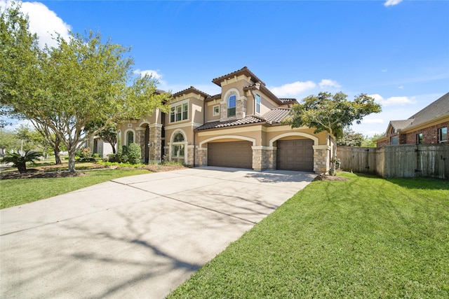 7106 Sentinel Fls, Missouri City, TX 77459 - mediterranean / spanish-style house with stucco siding, stone siding, driveway, a tile roof, and an attached garage