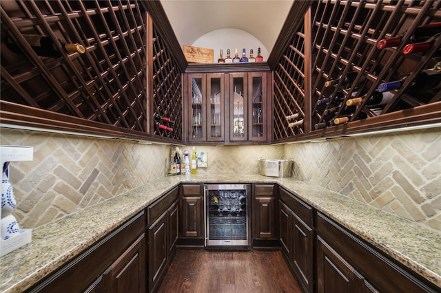 7106 Sentinel Fls, Missouri City, TX 77459 - wine cellar featuring beverage cooler, wet bar, and dark wood-type flooring