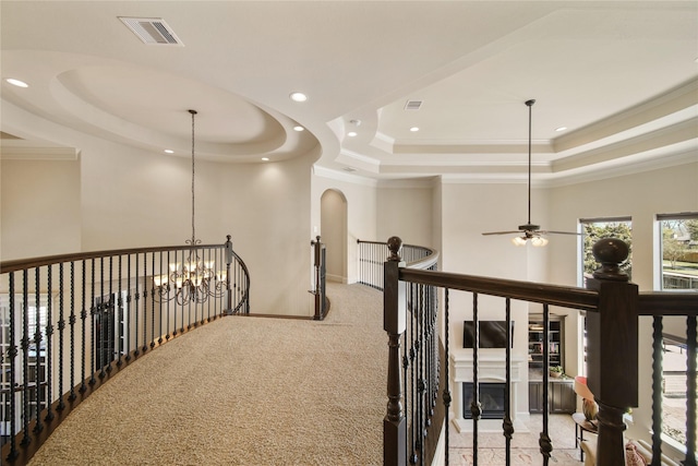 7106 Sentinel Fls, Missouri City, TX 77459 - corridor with a tray ceiling, an upstairs landing, crown molding, a chandelier, and carpet flooring