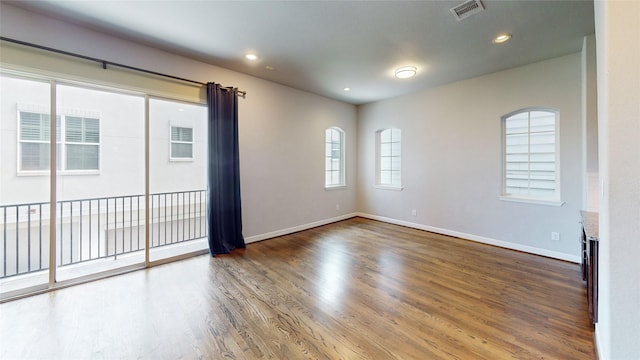 1913 Hickory St, Houston, TX 77007 - empty room with wood finished floors, baseboards, and recessed lighting