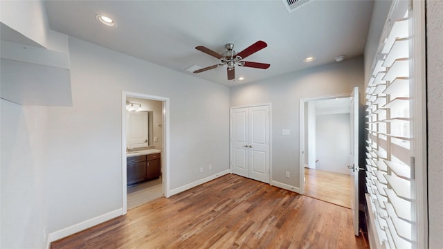 1913 Hickory St, Houston, TX 77007 - unfurnished bedroom with light wood-style floors, baseboards, recessed lighting, ensuite bath, and a closet