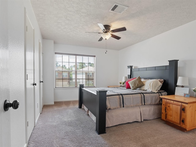 11823 Elizabeth Ct, Pinehurst, TX 77362 - bedroom featuring light carpet, a textured ceiling, baseboards, and a ceiling fan