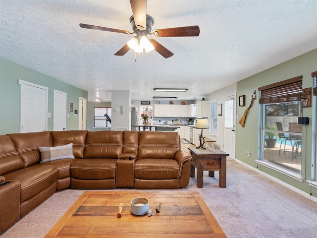 11823 Elizabeth Ct, Pinehurst, TX 77362 - living area with a textured ceiling, light carpet, a ceiling fan, and healthy amount of natural light